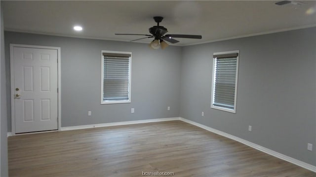 empty room featuring ceiling fan, light hardwood / wood-style flooring, and ornamental molding