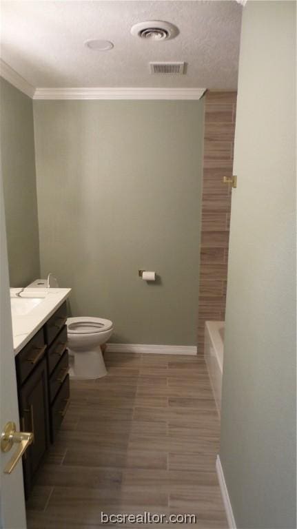 bathroom featuring ornamental molding, vanity, wood-type flooring, and toilet