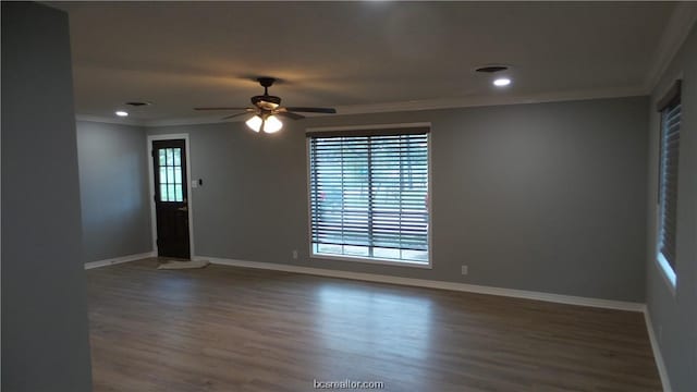 unfurnished room with dark hardwood / wood-style floors, ceiling fan, and crown molding