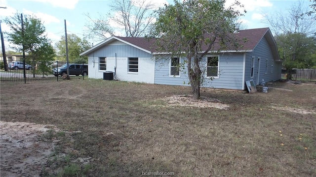 rear view of property with a lawn