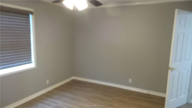 empty room featuring hardwood / wood-style flooring and ceiling fan