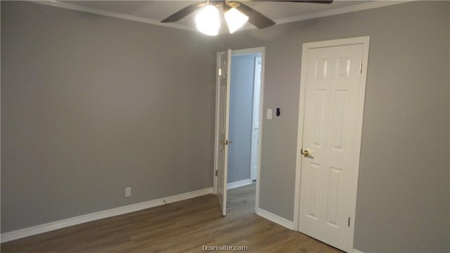 empty room with hardwood / wood-style floors, ceiling fan, and ornamental molding