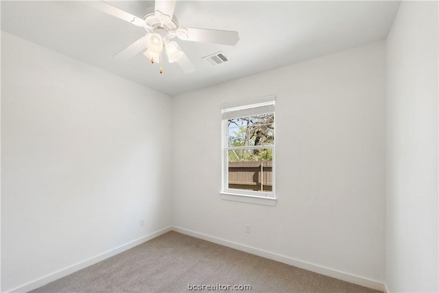 carpeted spare room featuring ceiling fan