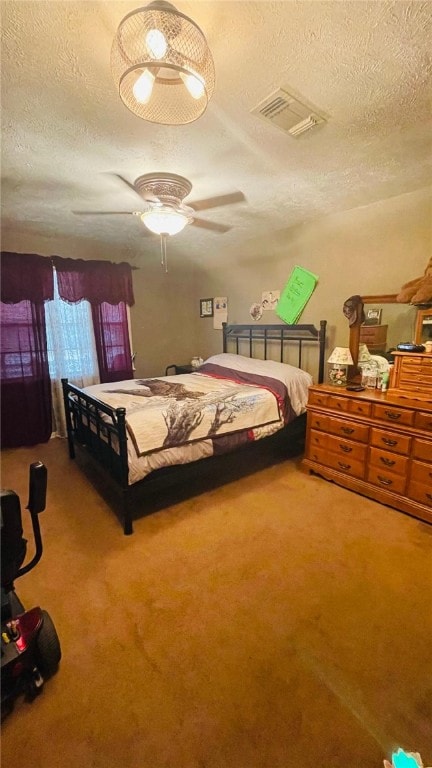 bedroom with ceiling fan, a textured ceiling, and carpet flooring