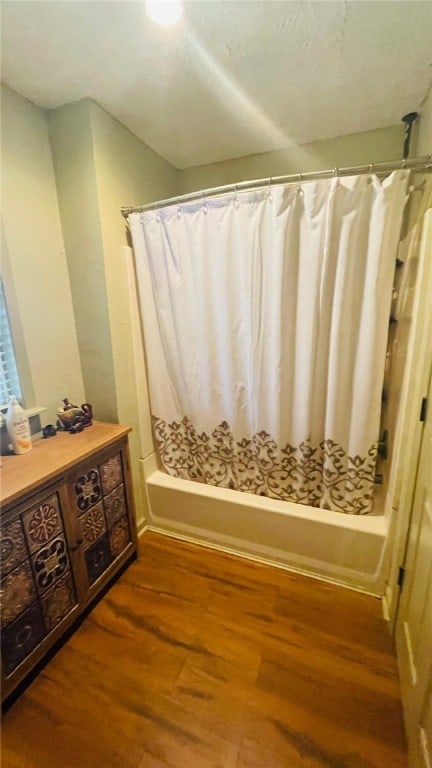 bathroom featuring shower / bath combo and hardwood / wood-style floors