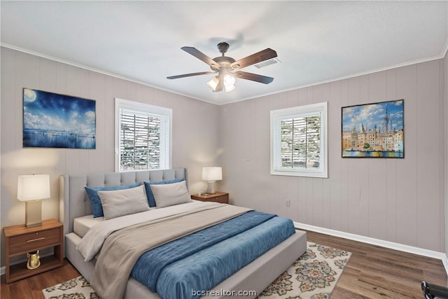 bedroom with multiple windows, ceiling fan, and dark hardwood / wood-style flooring