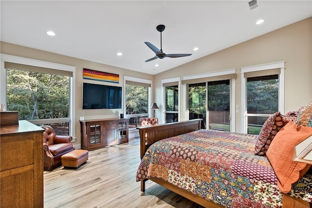 bedroom featuring light hardwood / wood-style floors, vaulted ceiling, multiple windows, and ceiling fan