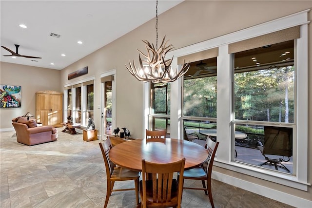 dining room with a healthy amount of sunlight and ceiling fan with notable chandelier