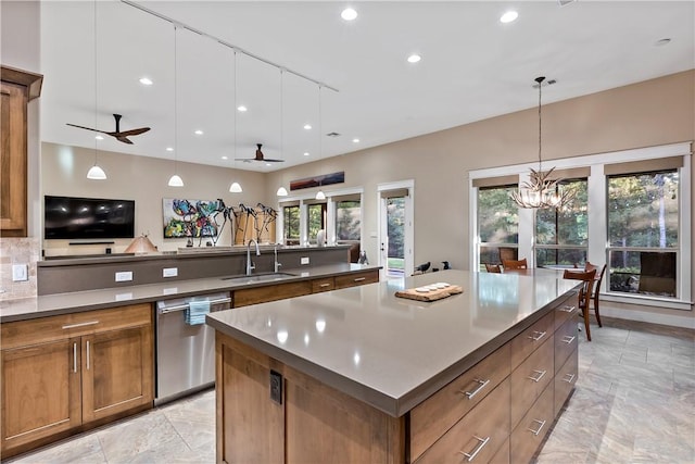 kitchen featuring dishwasher, a healthy amount of sunlight, sink, and ceiling fan with notable chandelier