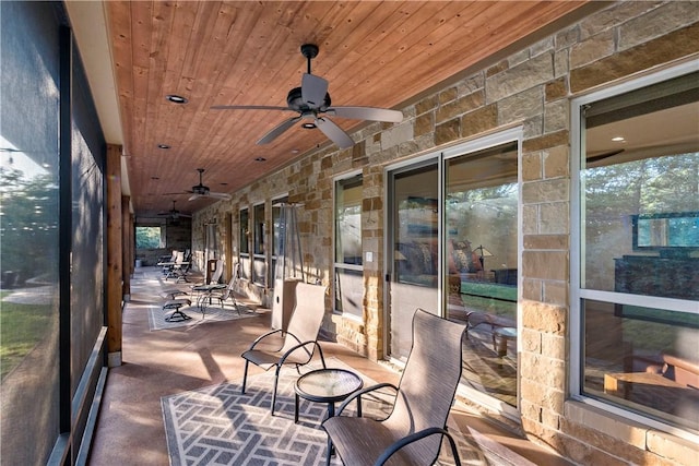 sunroom / solarium with ceiling fan and wooden ceiling