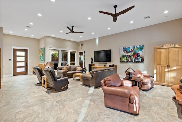 living room featuring ceiling fan and french doors