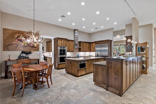 kitchen with stainless steel appliances, a kitchen island, and hanging light fixtures