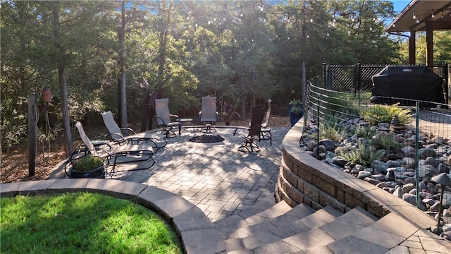 view of patio / terrace featuring area for grilling and a fire pit