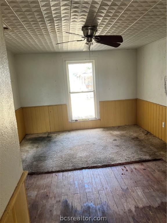 spare room with hardwood / wood-style floors and ceiling fan