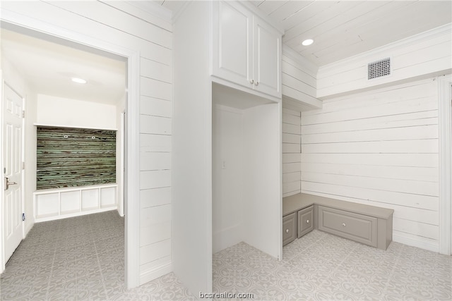 mudroom with wood walls