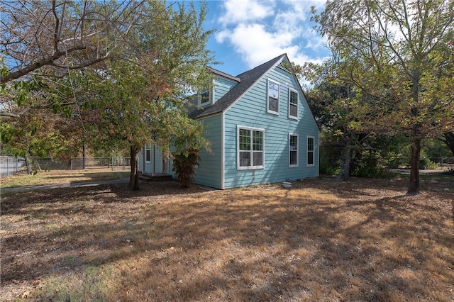 view of side of property featuring a yard