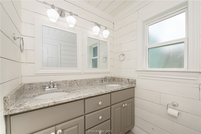 bathroom with vanity and wooden walls