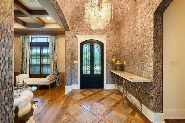 17288 Indian Lakes Dr, College Station, TX 77845 - foyer with a chandelier, wainscoting, arched walkways, beamed ceiling, and inlaid floor details