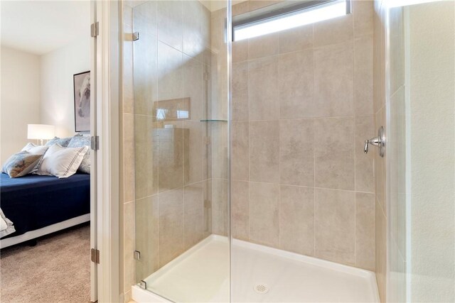 bathroom with tile patterned flooring and walk in shower