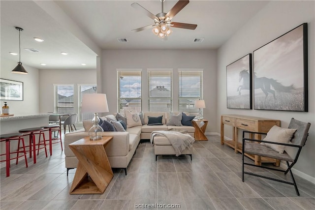 living room featuring ceiling fan and light tile patterned floors