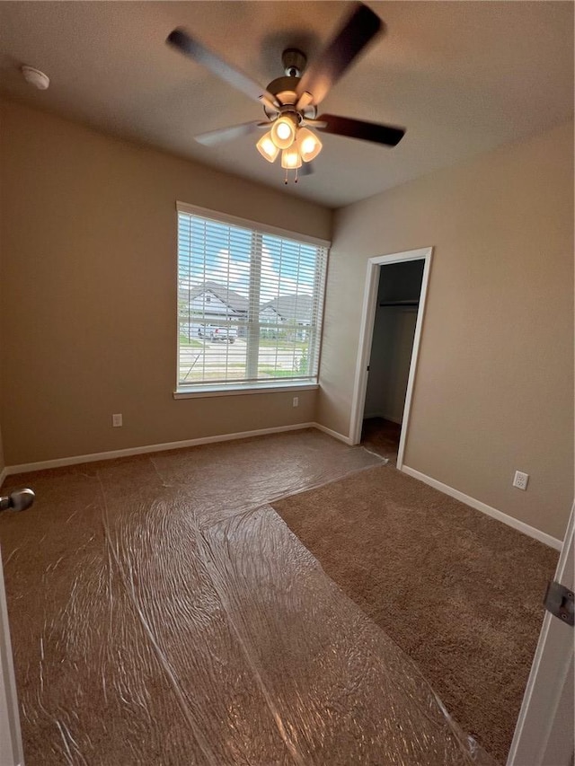 empty room with carpet and ceiling fan