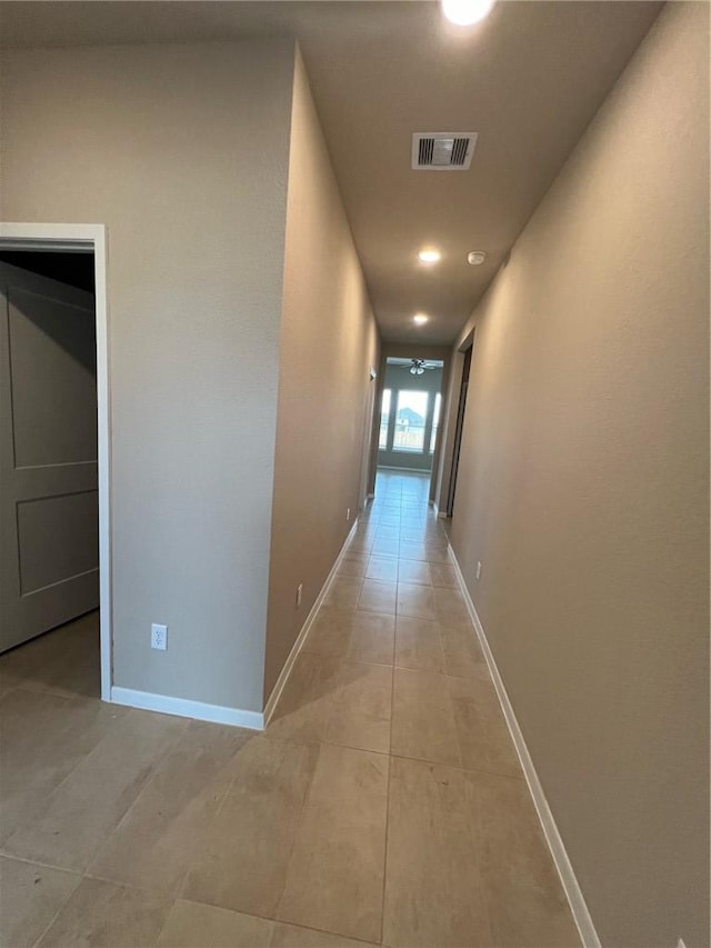 hall with light tile patterned floors