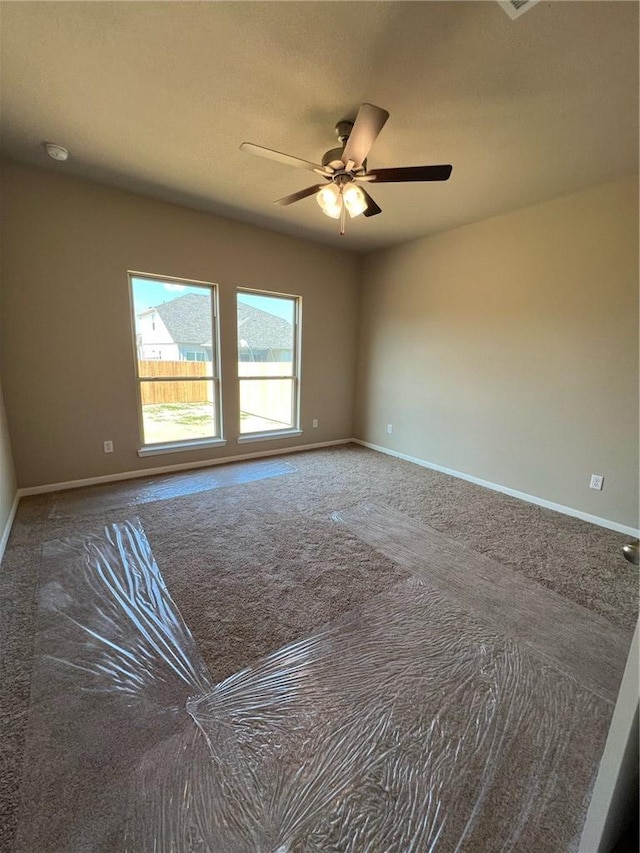 spare room with carpet flooring and ceiling fan