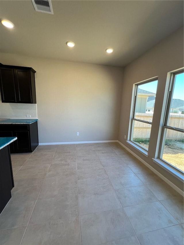 interior space with light tile patterned floors and a wealth of natural light