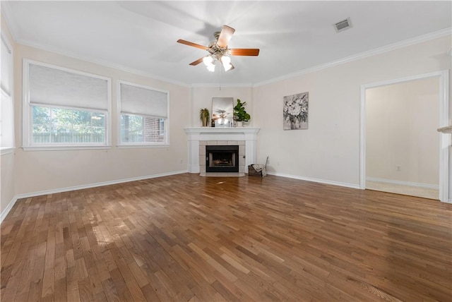 unfurnished living room featuring ceiling fan, dark hardwood / wood-style flooring, a fireplace, and crown molding