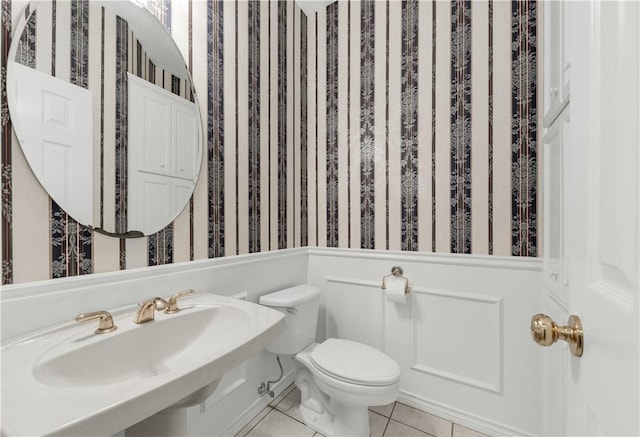 bathroom with tile patterned flooring, toilet, and sink