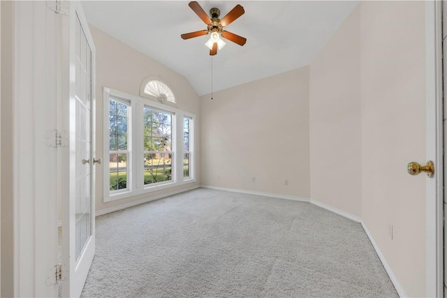 carpeted empty room with ceiling fan and vaulted ceiling