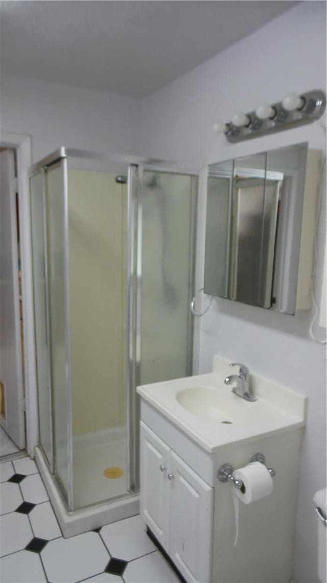 bathroom with vanity, toilet, and walk in shower