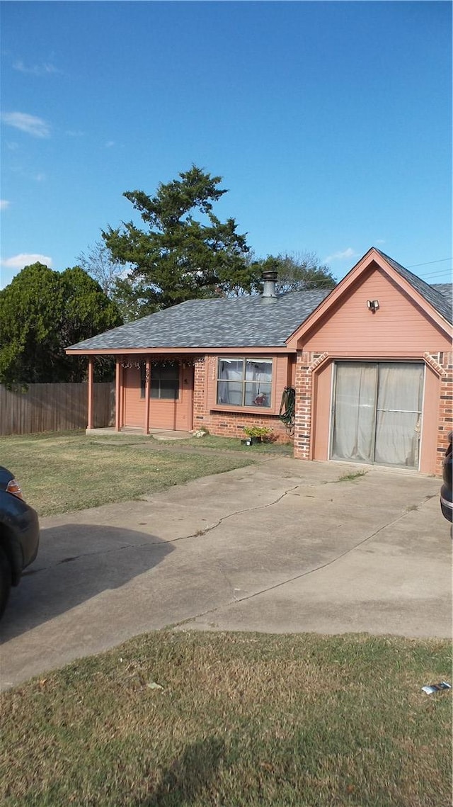 view of front of property with a front yard and a garage