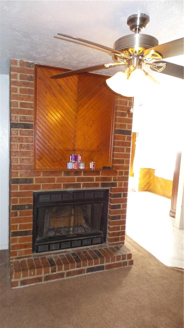 interior details featuring carpet, a brick fireplace, a textured ceiling, ceiling fan, and wooden walls