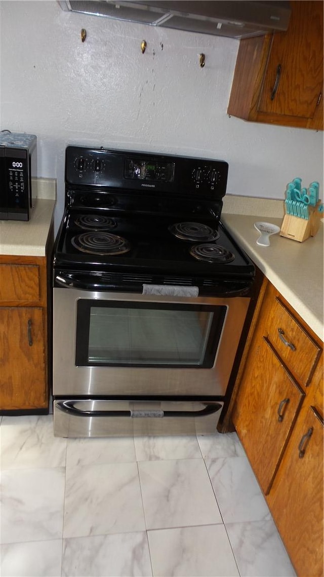 kitchen with electric range and ventilation hood