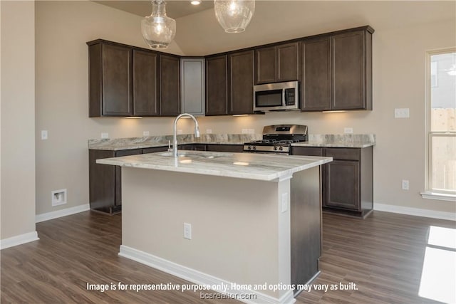 kitchen with dark brown cabinets, light stone counters, stainless steel appliances, and dark wood-type flooring