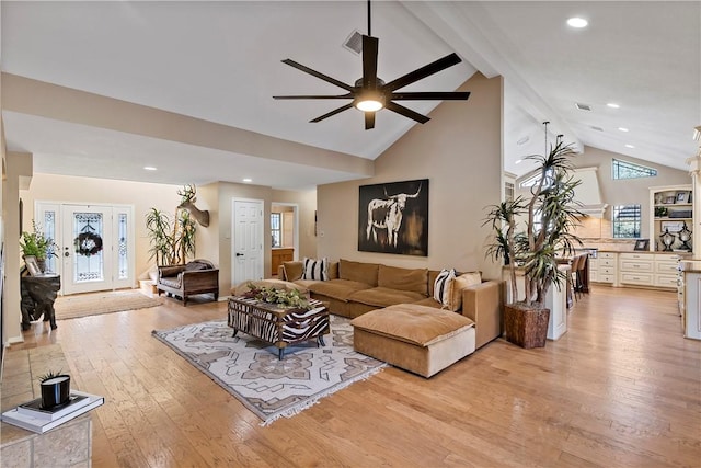 living room featuring beam ceiling, ceiling fan, high vaulted ceiling, and light wood-type flooring