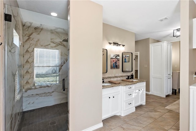 bathroom featuring tile patterned flooring, vanity, and an enclosed shower