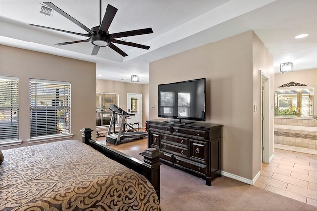 tiled bedroom with connected bathroom and ceiling fan