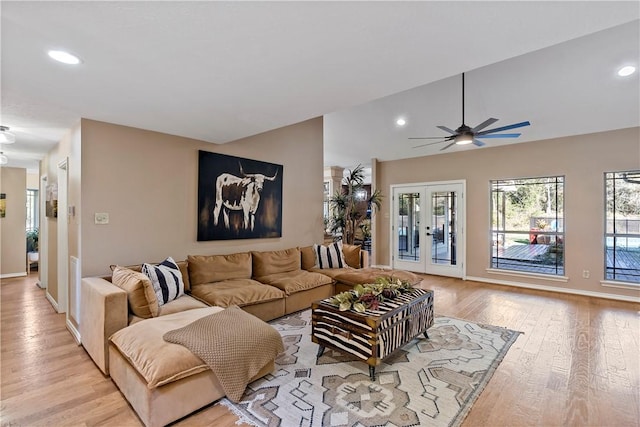 living room featuring ceiling fan, french doors, and light hardwood / wood-style flooring