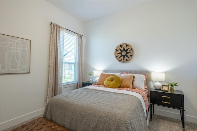 carpeted bedroom featuring baseboards