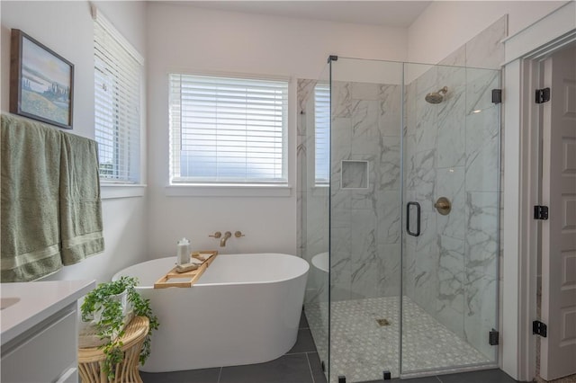 full bath featuring vanity, tile patterned flooring, a marble finish shower, and a freestanding bath