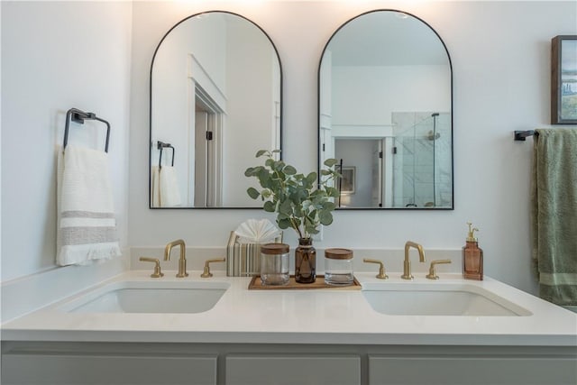 bathroom featuring double vanity, walk in shower, and a sink