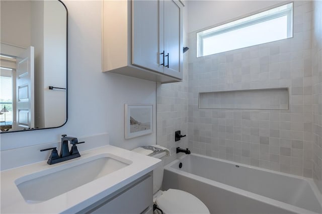 bathroom with tub / shower combination, toilet, and vanity