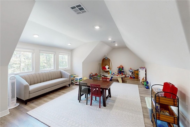 rec room with light wood-type flooring and vaulted ceiling