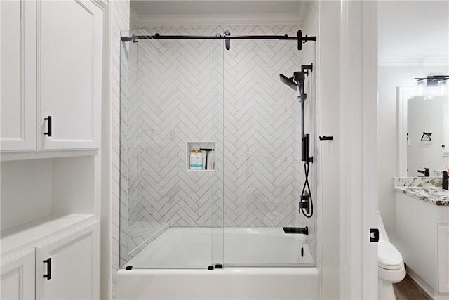 full bathroom featuring toilet, vanity, bath / shower combo with glass door, and ornamental molding