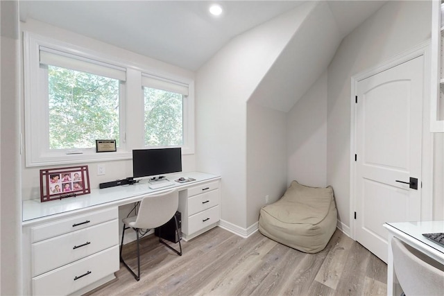 office area with vaulted ceiling and light wood-type flooring