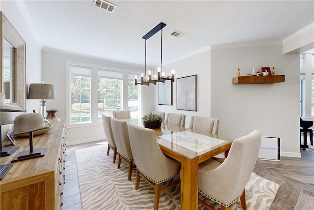 dining space with ornamental molding and a notable chandelier