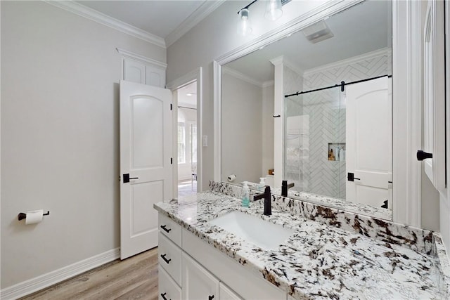 bathroom featuring a shower, hardwood / wood-style floors, vanity, and crown molding