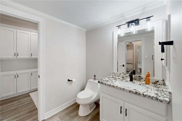 bathroom featuring hardwood / wood-style floors, vanity, toilet, and ornamental molding